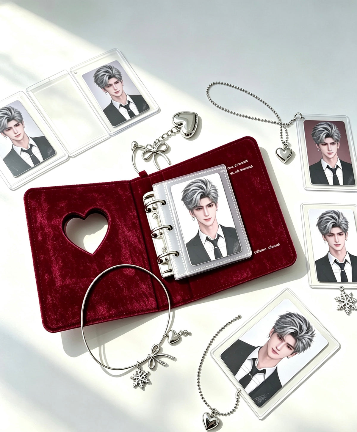 Burgundy velvet photo card binder open with cards and silver charm accessories laid out